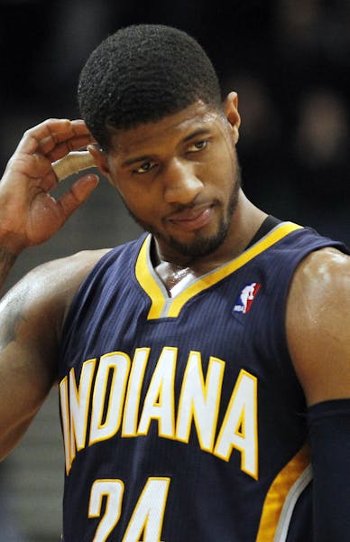 Indiana Pacers forward Paul George reacts late in the fourth quarter against the Minnesota Timberwolves during an NBA basketball game, Wednesday, Feb.