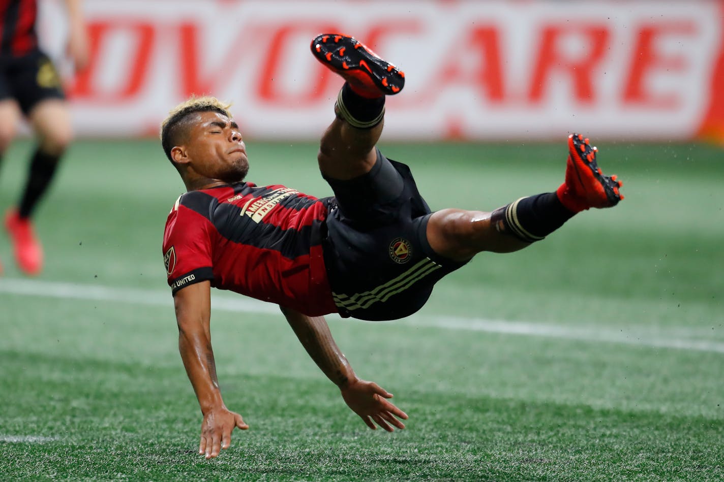 Atlanta United forward Josef Martinez (7) battles for there ball in the first half of an MLS soccer game against the D.C. United on Sunday, March 11, 2018, in Atlanta. (AP Photo/Todd Kirkland)