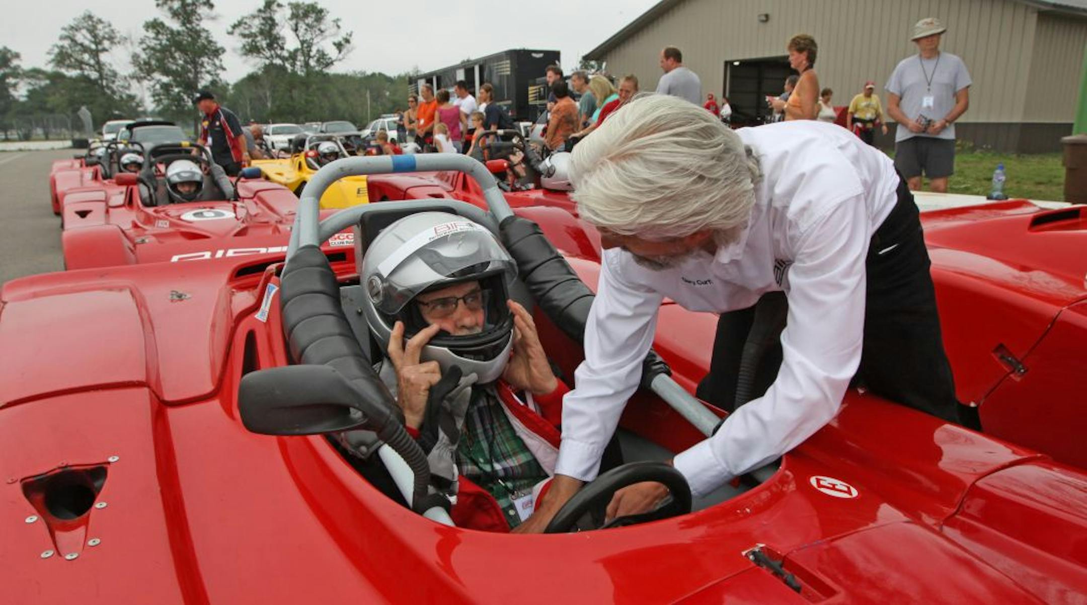 Student Jack Dejoy got help with his belts from Brainerd International Raceway Performance Driving School lead instructor Gary Curtis.