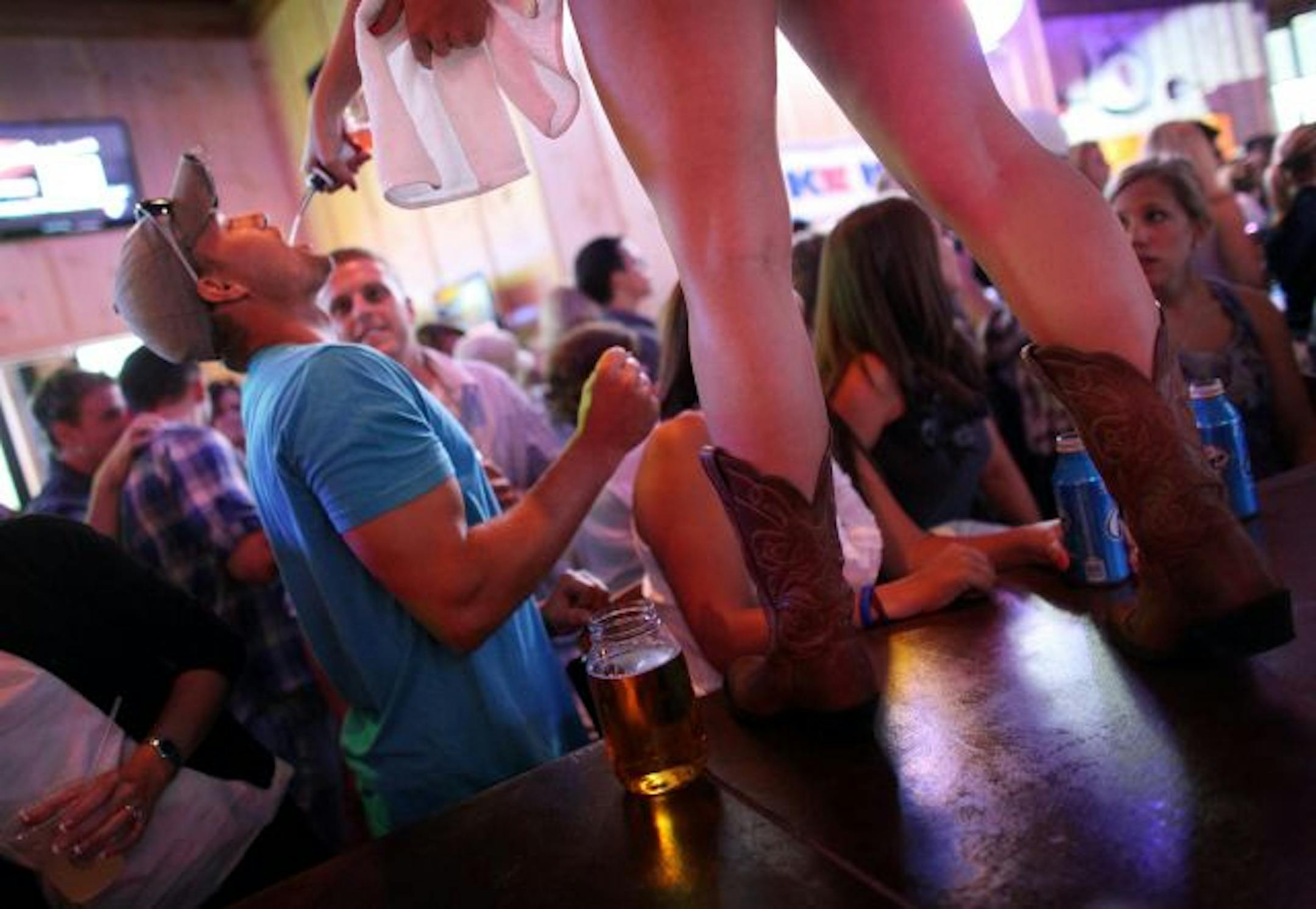 Jake Kizewski received a complimentary shot from a bartender standing on the bar at Toby Keith's I Love This Bar & Grill in St. Louis Park.