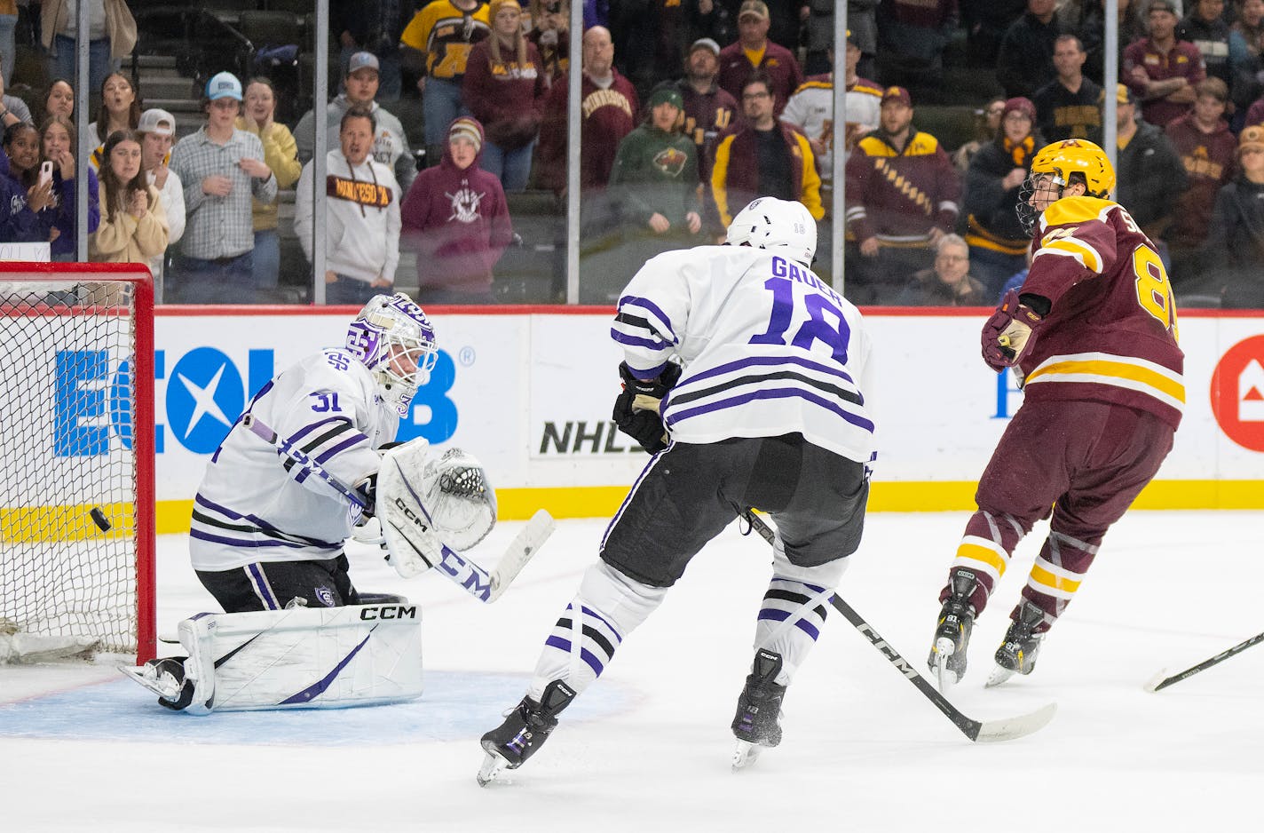 Minnesota forward Jimmy Snuggerud (81) scores the game winning goal on St. Thomas goaltender Aaron Trotter (31) in the overtime to give the Gophers a 6-5 win Friday, Oct. 13, 2023, at Xcel Energy Arena in St. Paul, Minn. ]