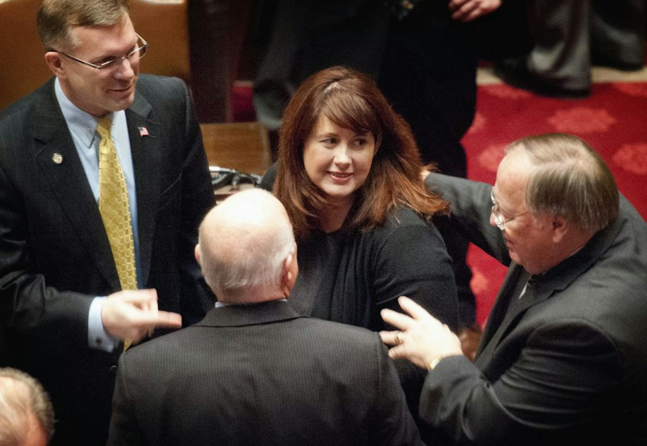 Sen. Amy Koch was greeted by Republicans Ted Daley, left, and David Sanjem, right, in her first floor appearance since being ousted as majority leader.