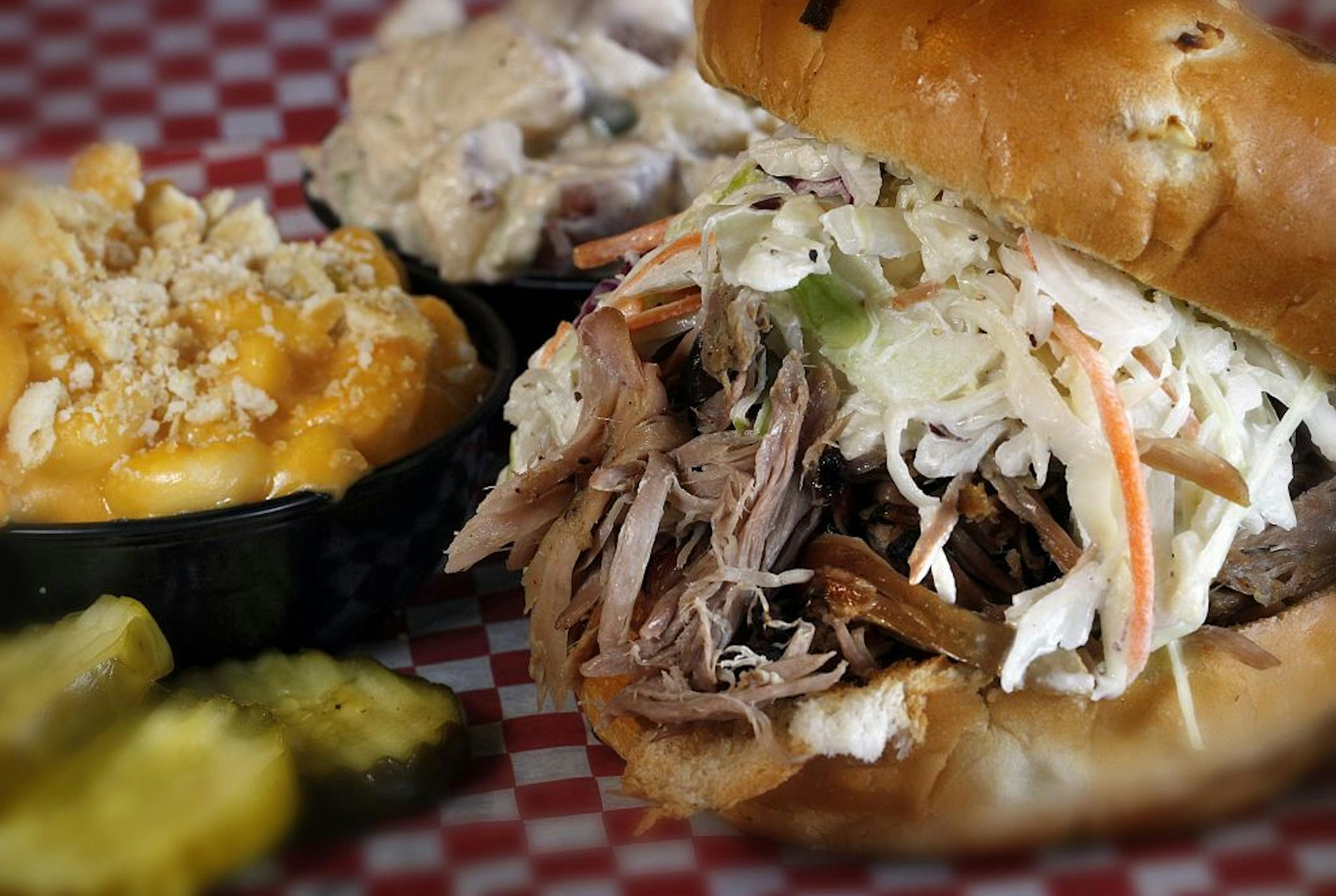 Lunch at the Rack Shack BBQ in Burnsville: The pulled pork sandwich, topped with cole slaw and served with macaroni and cheese and potato salad.