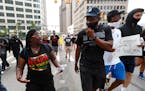 A protester talks with Detroit Pistons head coach Dwane Casey during a march in Detroit, Thursday, June 4, 2020 over the death of George Floyd, a blac