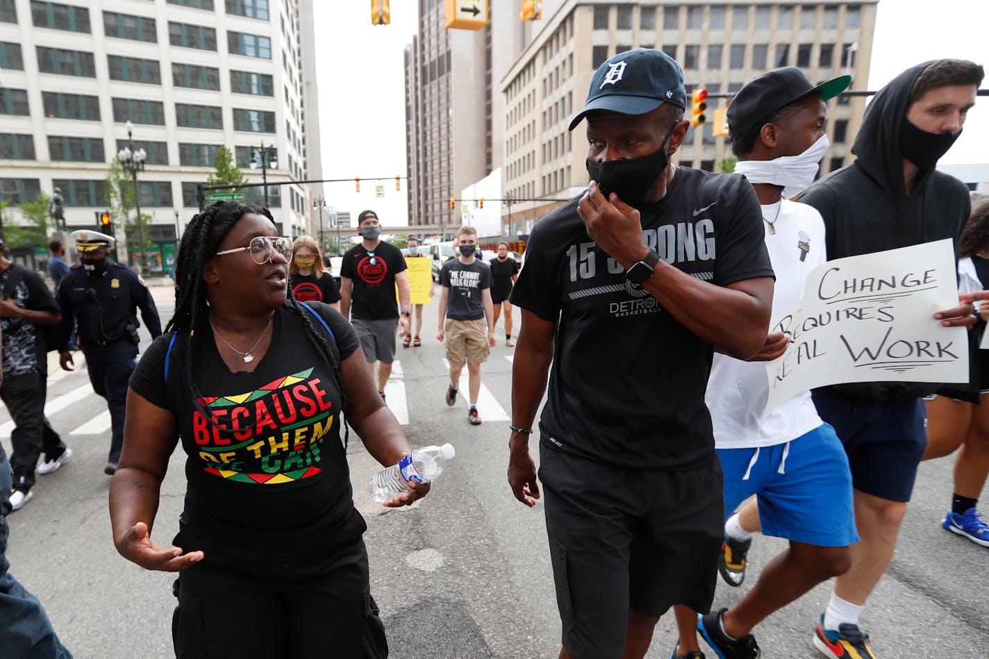 A protester talks with Detroit Pistons head coach Dwane Casey during a march in Detroit, Thursday, June 4, 2020 over the death of George Floyd, a black man who was in police custody in Minneapolis. Floyd died after being restrained by Minneapolis police officers on Memorial Day. (AP Photo/Paul Sancya)