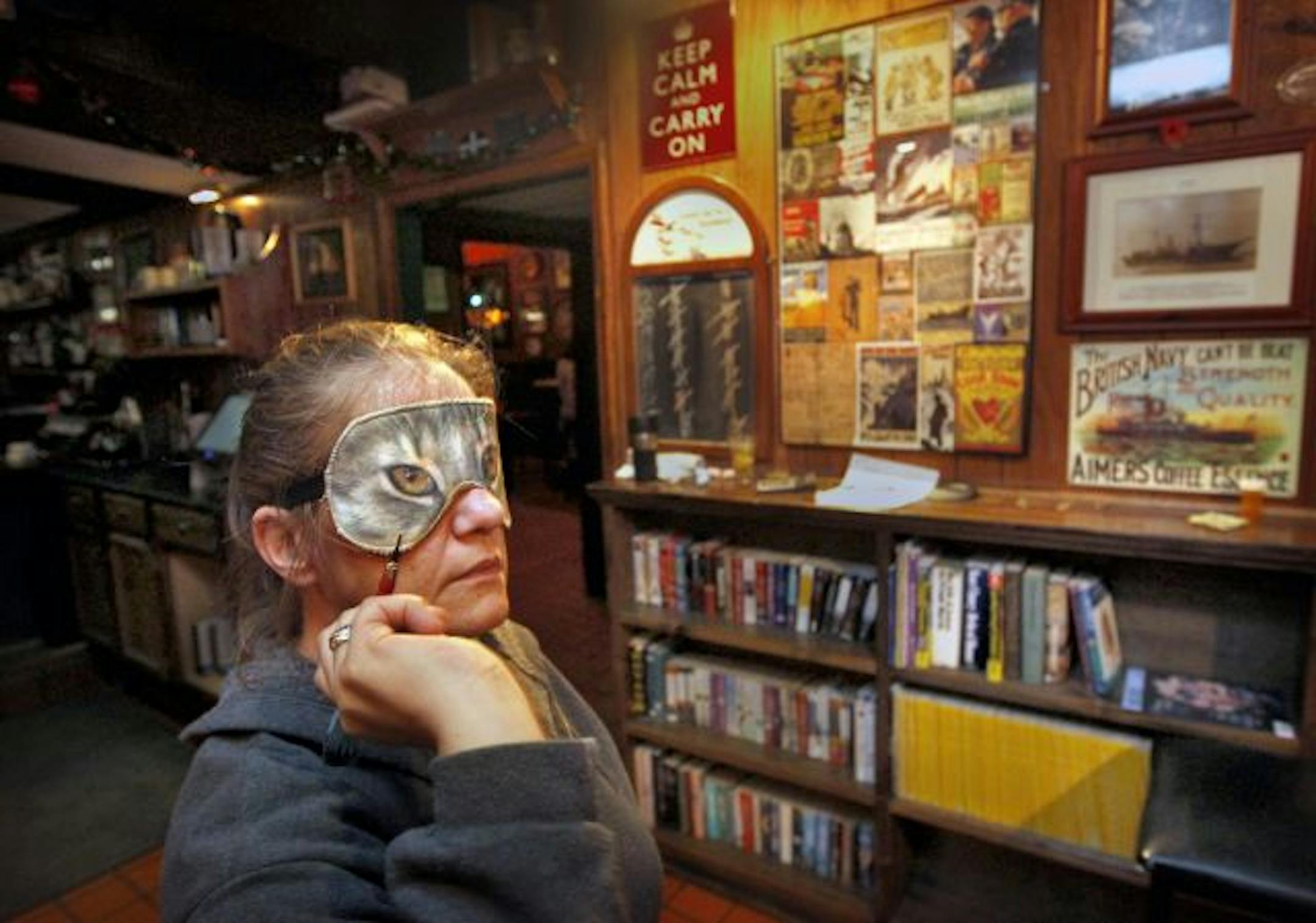 With her cat-face mask, Ellen Llanas shoots for the prrrrr-fect blind darts game.