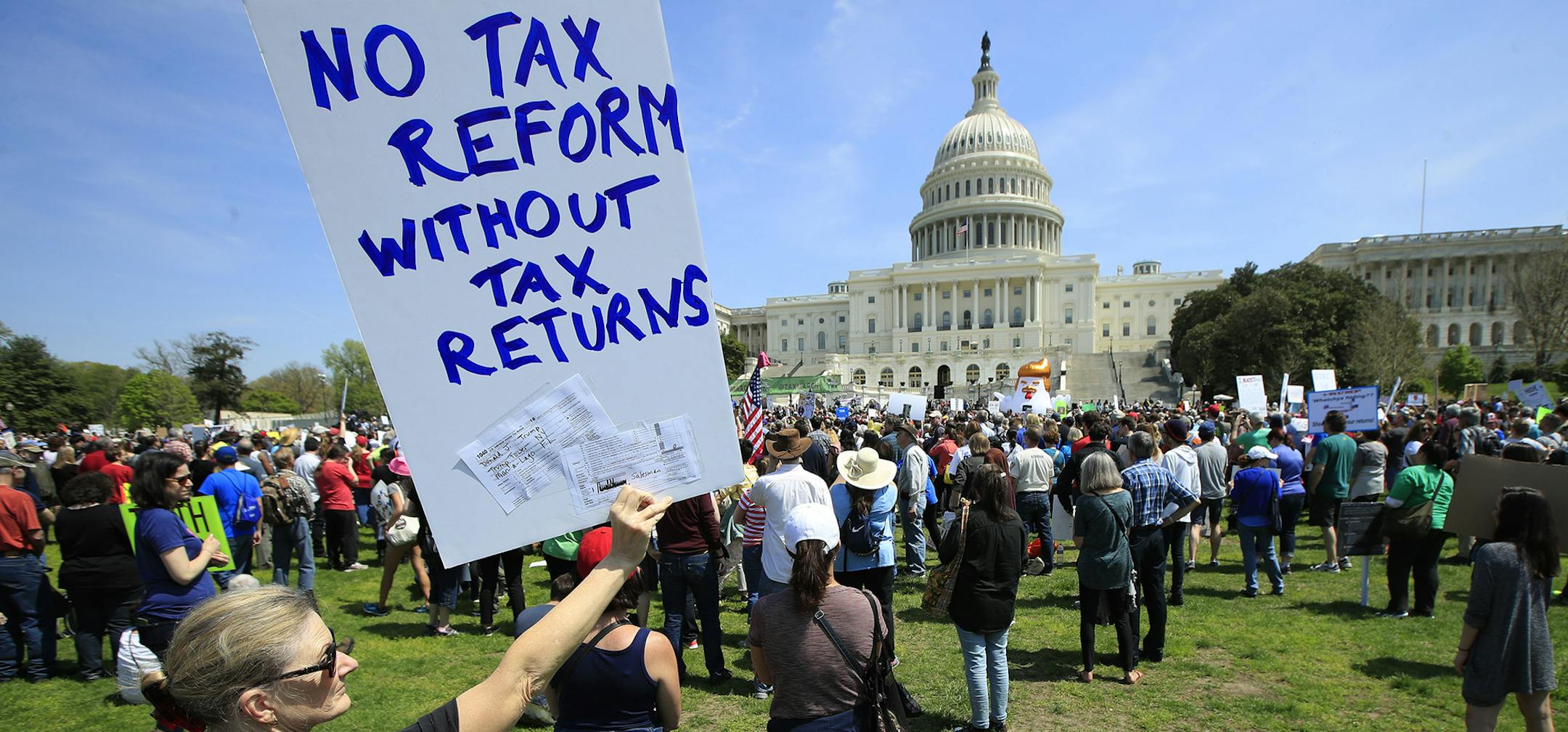 Protesters are gather on Capitol Hill in Washington, Saturday, April 15, 2017, during a Tax Day demonstration calling on President Donald Trump to release his tax returns. (AP Photo/Manuel Balce Ceneta) ORG XMIT: MIN2017041713461840