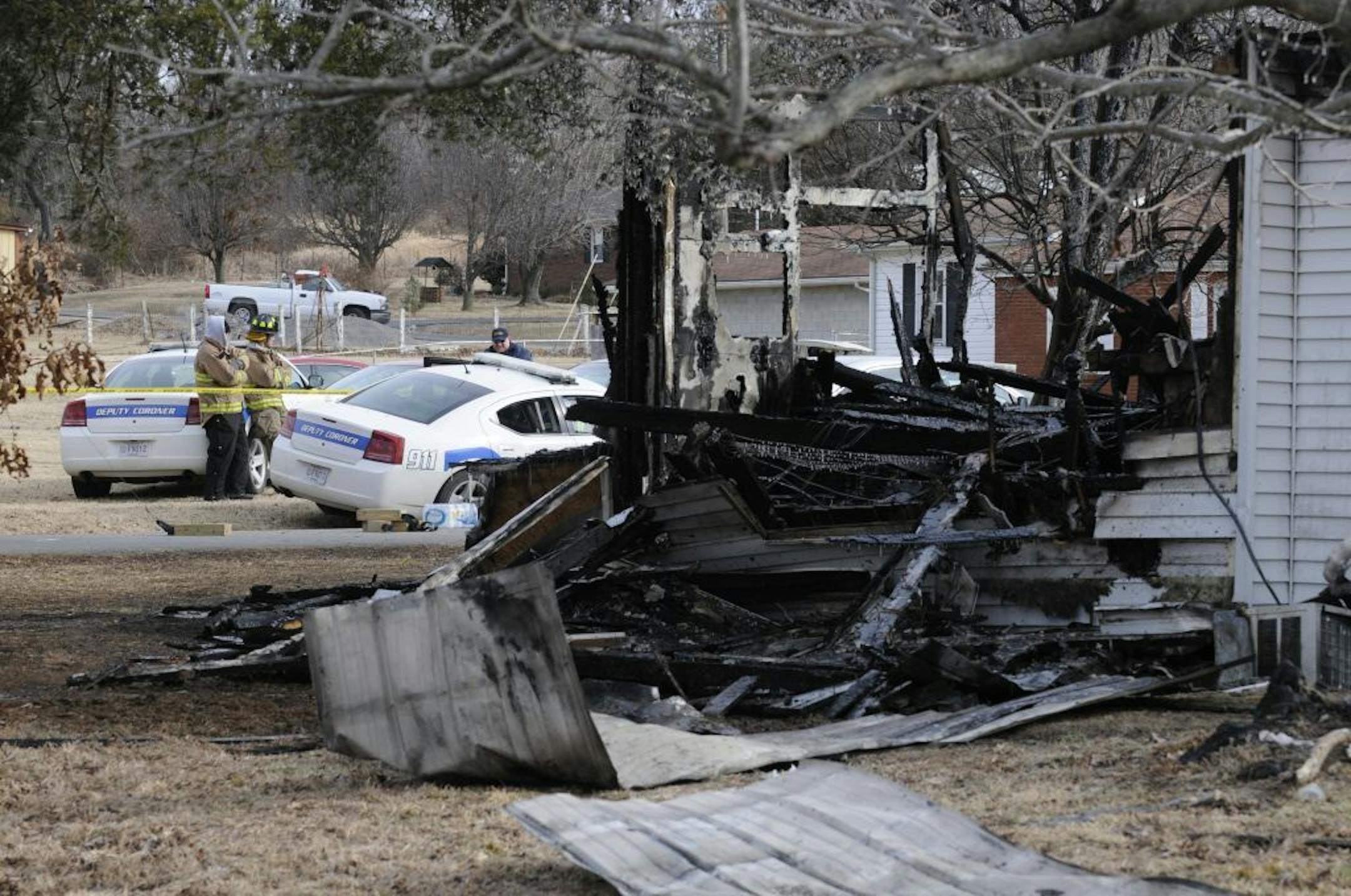 Mike Lawrence/The Gleaner Fire investigators work at the scene of early morning house fire near Greenville, Ky., Thurday Jan. 1, 2014. Nine people from a family of eleven are presumed dead in the fire.
