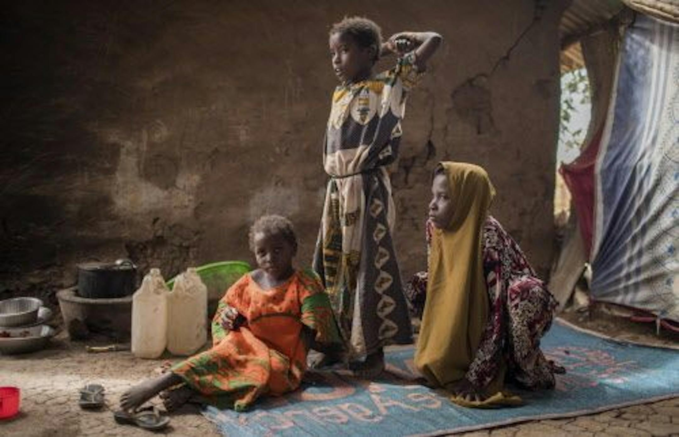 In this photo taken Tuesday, Aug. 1, 2017, Somali refugee girls Maryan Maday Jeylani, 6, left, Halima Alwahab Mohamed, 10, center, and Maka Abdiwahab Mohamed, 12, right, are seen in their home at Kakuma Refugee Camp in northern Kenya. For 10 years their mother went through a rigorous process of interviews and screening and finally was cleared to travel to the United States, but now their hopes have been dashed after the U.S. Supreme Court on Tuesday, Sept. 12, 2017 allowed the Trump administrati