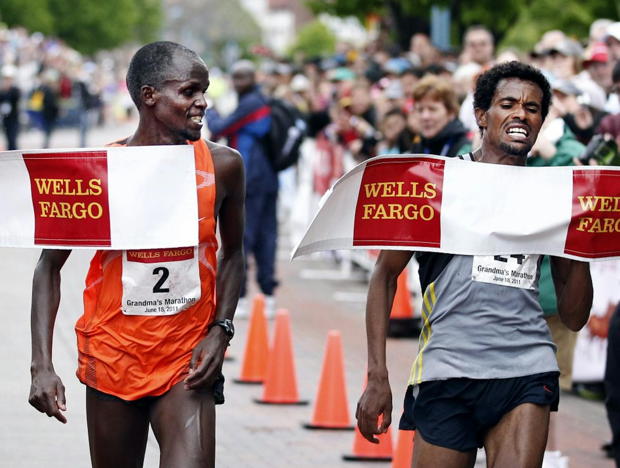 Christopher Kipyego (2) just beat Teklu Deneke (24) to the finish line with a time of 2:12:15 to Deneke's 2:12:35 to win The Grandma's Marathon.