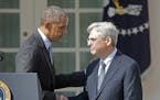 President Barack Obama, left, shakes hands with Judge Merrick Garland, chief justice for the U.S. Court of Appeals for the District of Columbia Circui