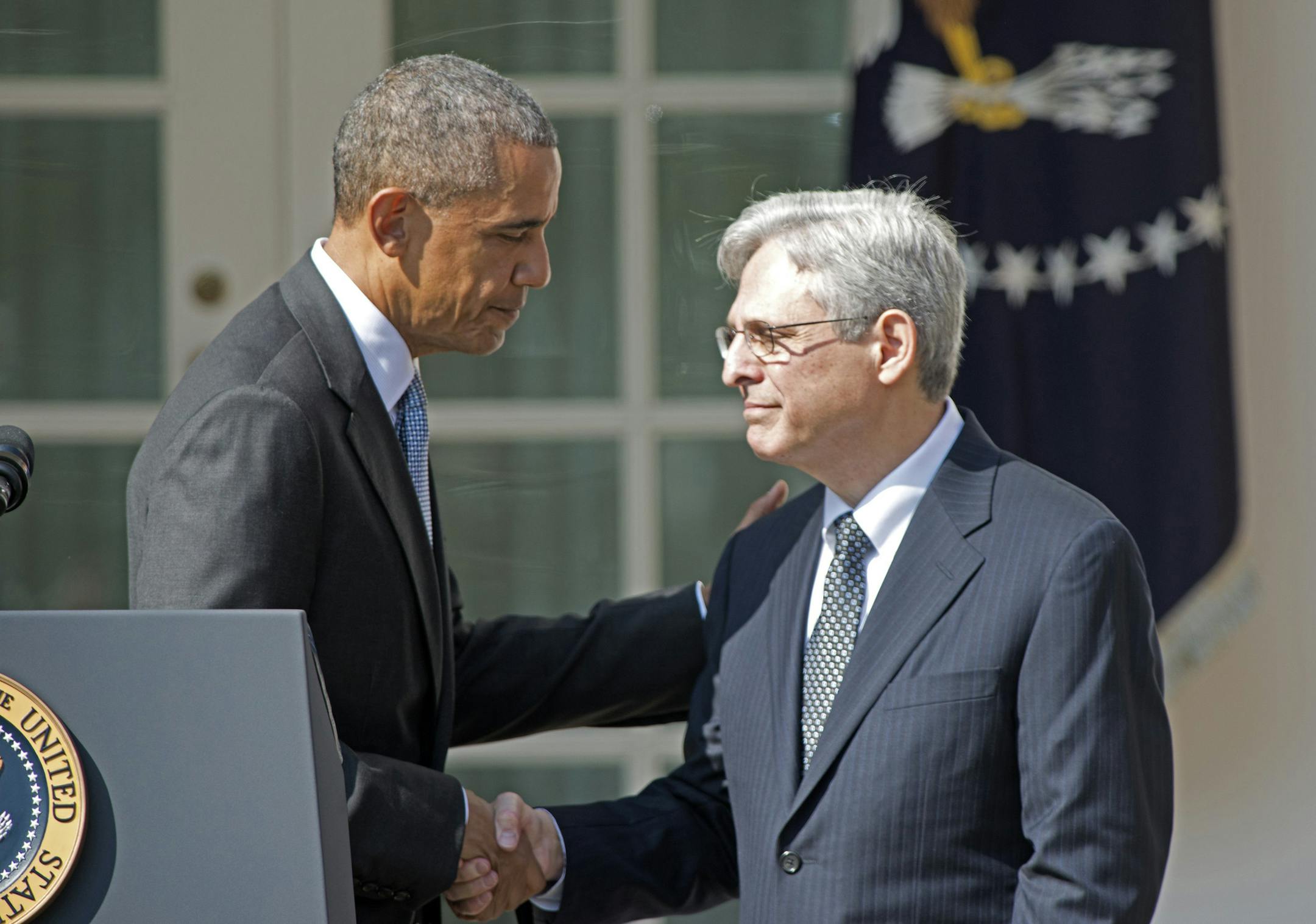 President Barack Obama, left, shakes hands with Judge Merrick Garland, chief justice for the U.S. Court of Appeals for the District of Columbia Circuit, right, after announcing him as his nominee for the Supreme Court in the Rose Garden of the White House on Wednesday, March 16, 2016.