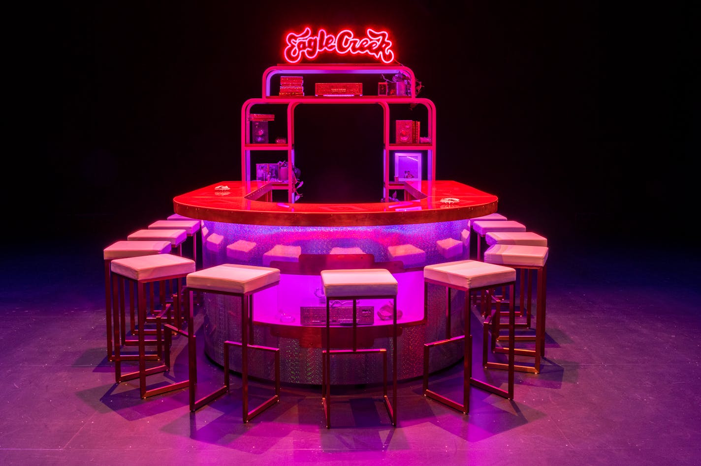 Walker Art Center's exhibit "The New Eagle Creek Saloon" by Sadie Barnette features a neon sign on a bar, as shown at The Kitchen in New York.