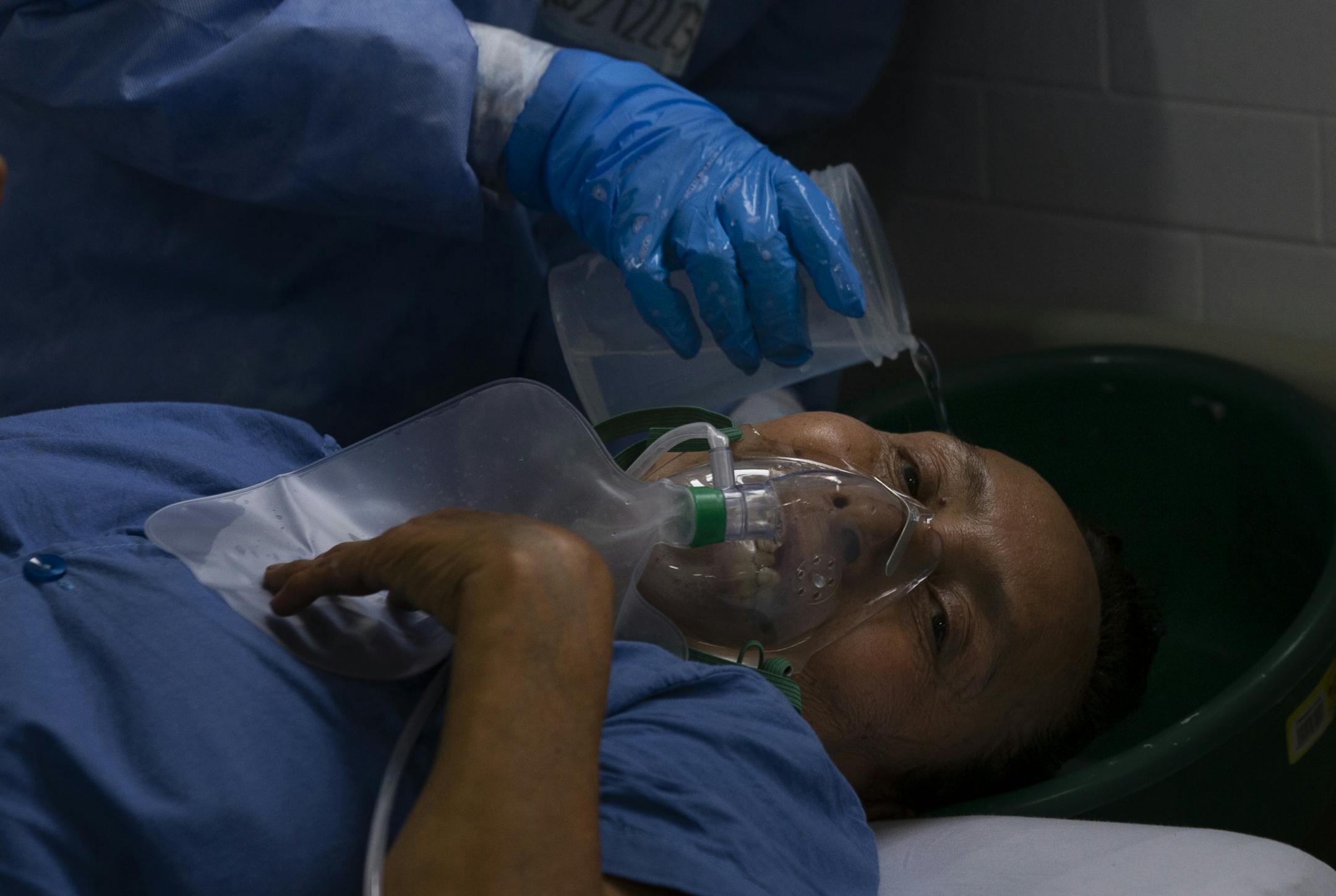 Dressed in protective gear to curb the spread of the new coronavirus, a medical worker washes a patient's hair, at a military hospital set up to take care of COVID-19 patients in Mexico City, Monday, November 30, 2020. As of last Friday, Mexico reported a record daily increase in the number of coronavirus cases, with Mexico City reporting the biggest portion of the surge in cases.