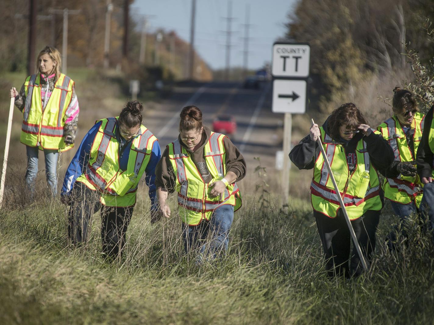 A group of volunteers searched the ditches along highway 8 in near the home where 13-year-old Jayme Closs lived with her parents James, and Denise Thursday October 18, 2018 in Barron, Wis.