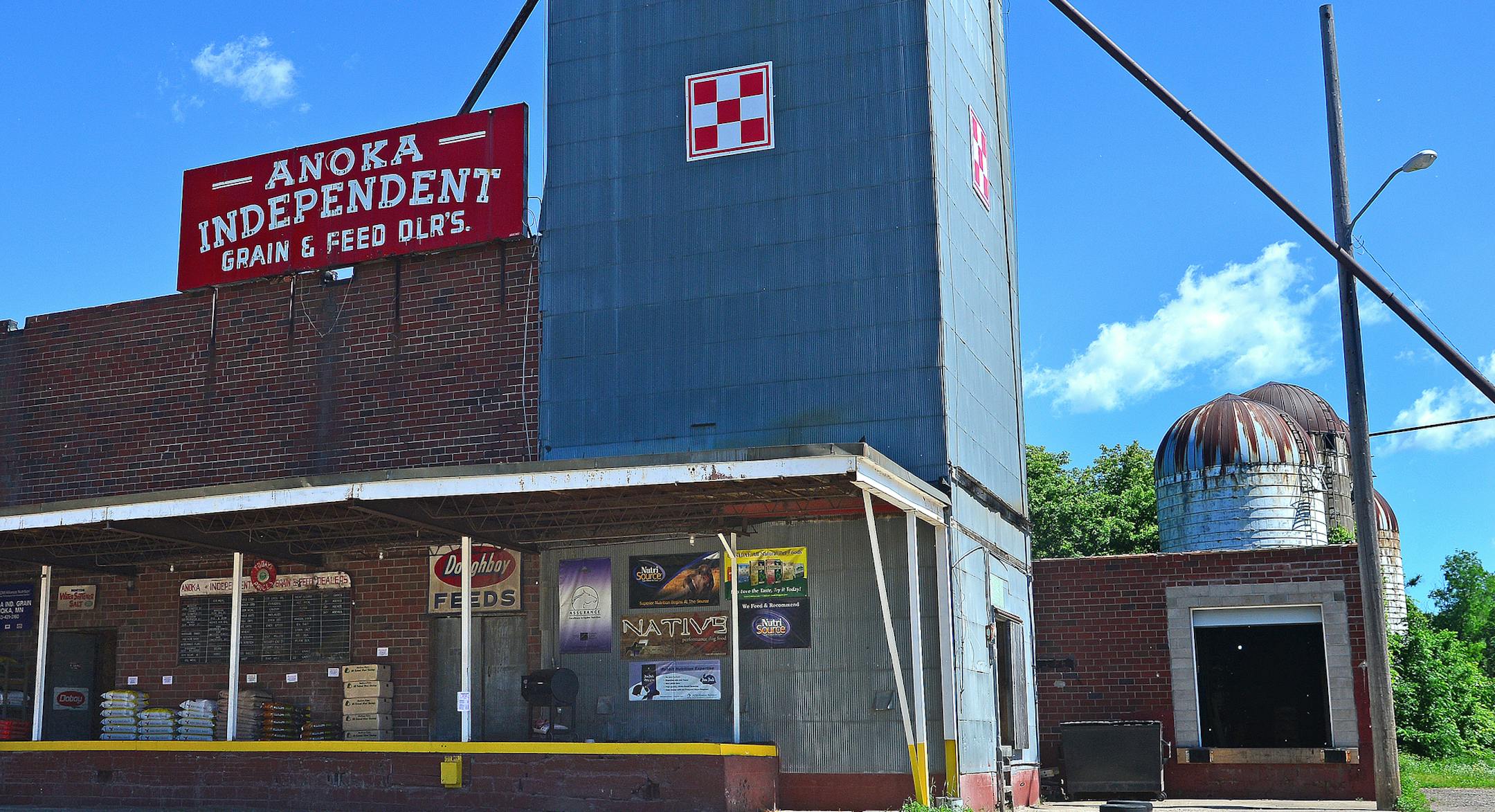 Two blocks from Anoka's city hall, the county government center and Main Street are a row of silos and a feed store that appears from another era. Anoka Independent Grain & Feed is such on oddity that couples come to pose there on their wedding day and graduates pose wearing caps and gowns. The store, operatng since 1948 alongside the Rum River, is more popular than ever, thanks to a new walking trail. ] Richard.Sennott@startribune.com Richard Sennott/Star Tribune Anoka Minnesota Thursday 6/27/1