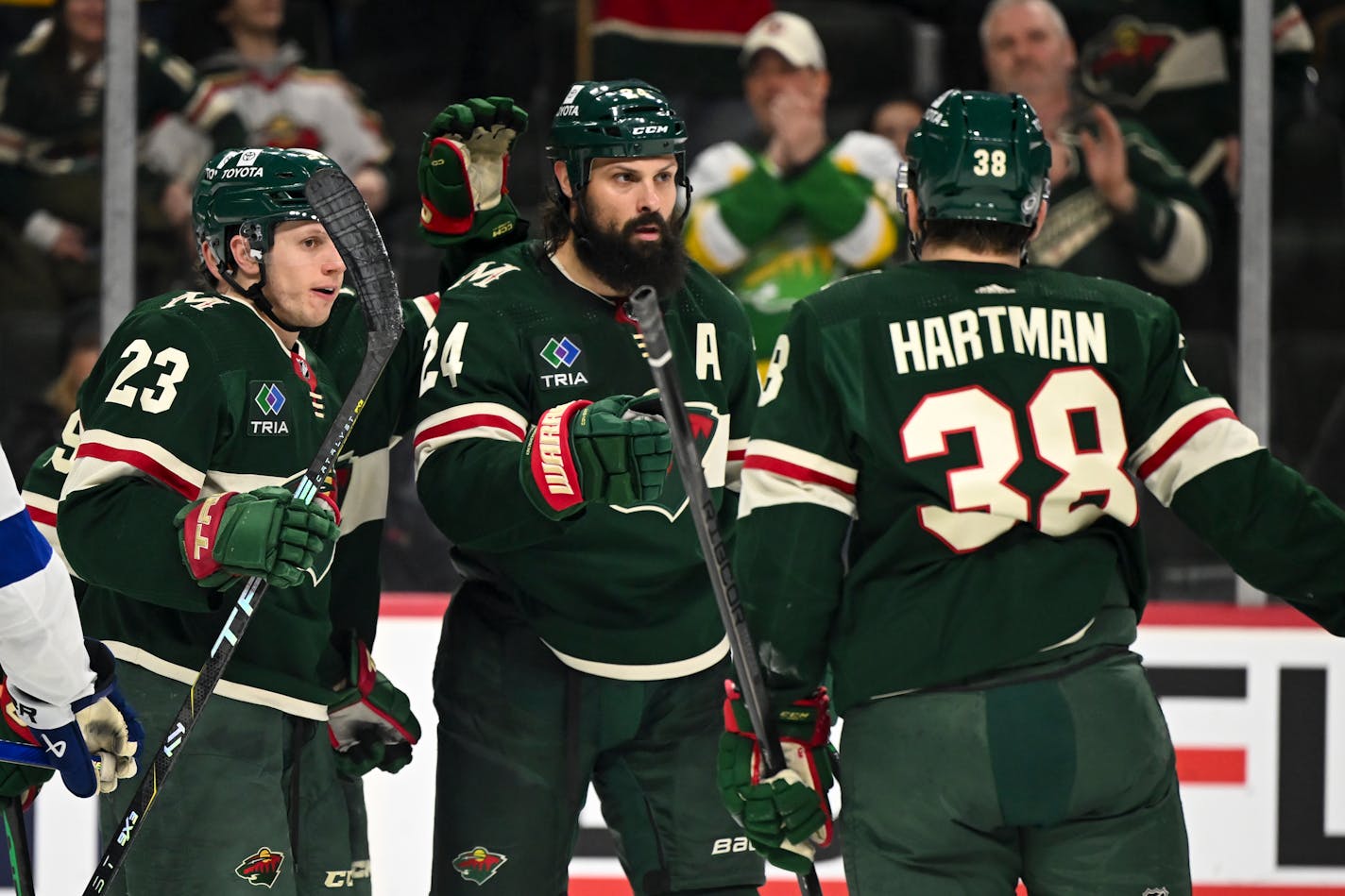 Minnesota Wild center Marco Rossi (23), right wing Ryan Hartman (38) and defenseman Zach Bogosian (24) celebrate a goal by Bogosian against the Tampa Bay Lightning during the third period Thursday, Jan. 4, 2024 at Xcel Energy Center in St. Paul, Minn.. ] AARON LAVINSKY • aaron.lavinsky@startribune.com