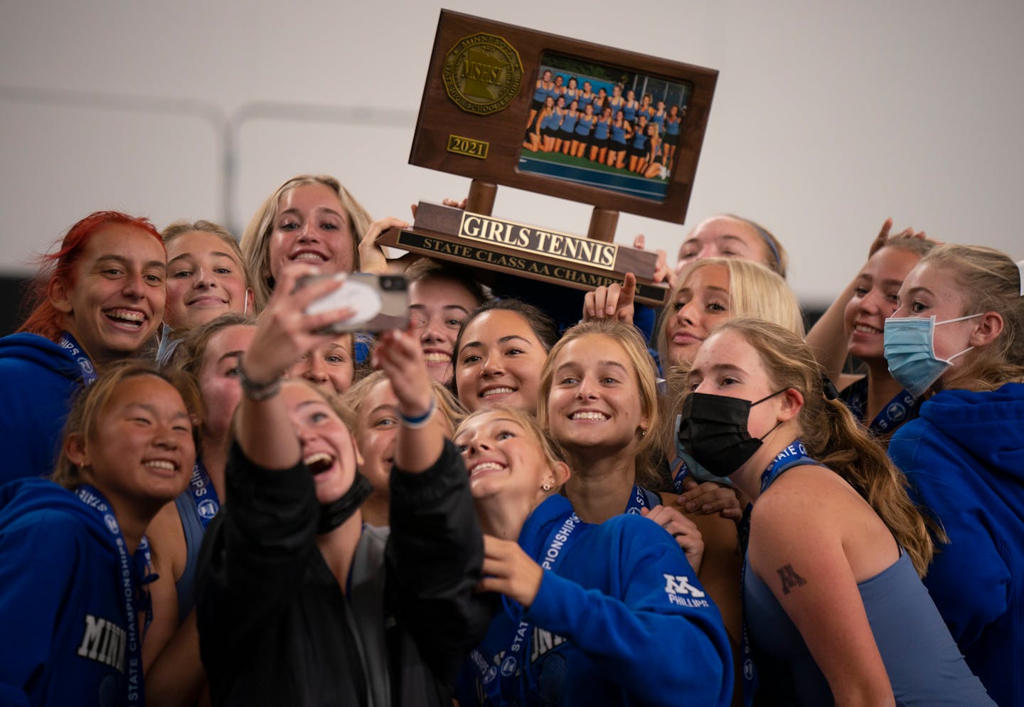 Minnetonka players took their own group selfie after the trophy presentation for their Class 2A championship Wednesday, Oct. 27, 2021 in Minneapolis. Minnetonka won the Class 2A girl's tennis state championship 6-1 over Blake at the Baseline Tennis Center Wednesday afternoon Wednesday, Oct. 27, 2021 in Minneapolis. ] JEFF WHEELER • Jeff.Wheeler@startribune.com