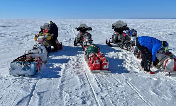 Riding identical Arctic Cat snowmobiles and pulling sleds filled with extra parts, food and other gear, Paul Dick, Rex Hibbert and Rob Hallstrom — "