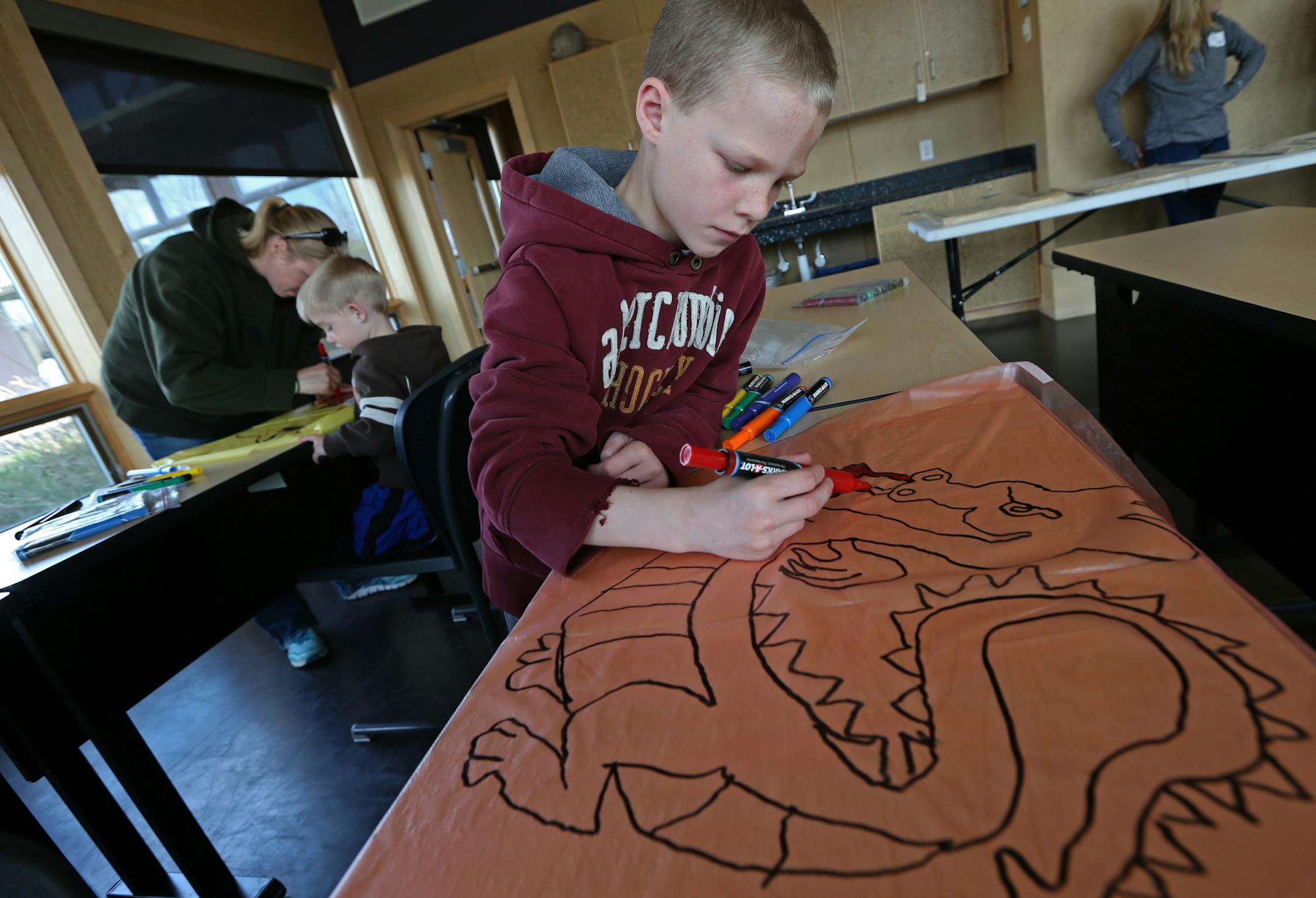Alex Burman, age-9 from Savage made a kite during a Minnesota Kite Society workshop at the Nature Fest 5th birthday celebration at the McColl Pond Environmental Learning Center on 5/10/14. The McColl Pond Environmental Learning Center in Savage, hailed as a groundbreaking way to educate the community about environmental issues when it opened in 2009, is celebrating its fifth "birthday." We'll look at how the first five years have gone and how well it's achieving its mission.] Bruce Bisping/Star