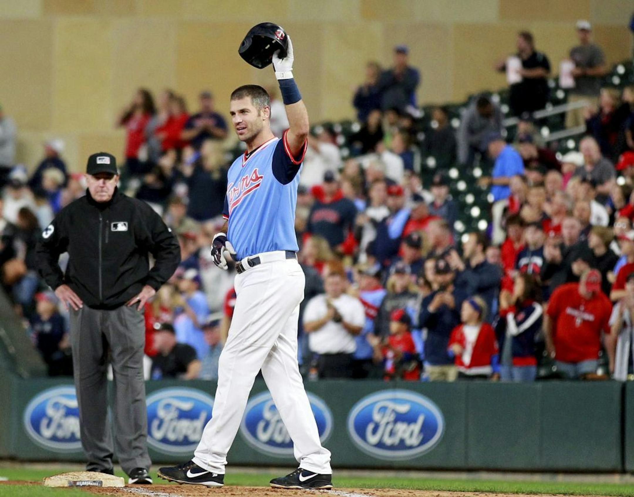 Minnesota Twins' Joe Mauer salutes the crowd after hitting a single against the Oakland Athletics in the fifth inning during a baseball game Friday, Aug. 24, 2018 in Minneapolis. It was Mauer's 2,086th career hit.