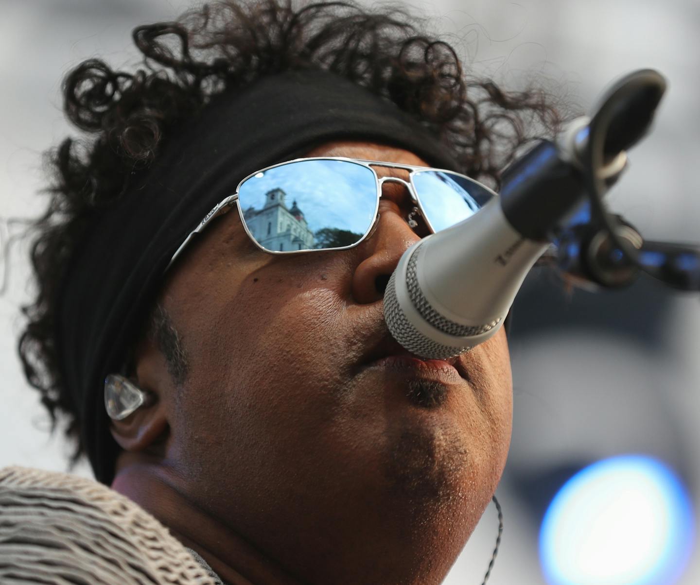 The Basilica of St. Mary is reflected in the glasses of bass player and lead vocal Brown Mark as The Revolution played the Basilica Block Party Friday, July 6, 2018, in Minneapolis, MN.