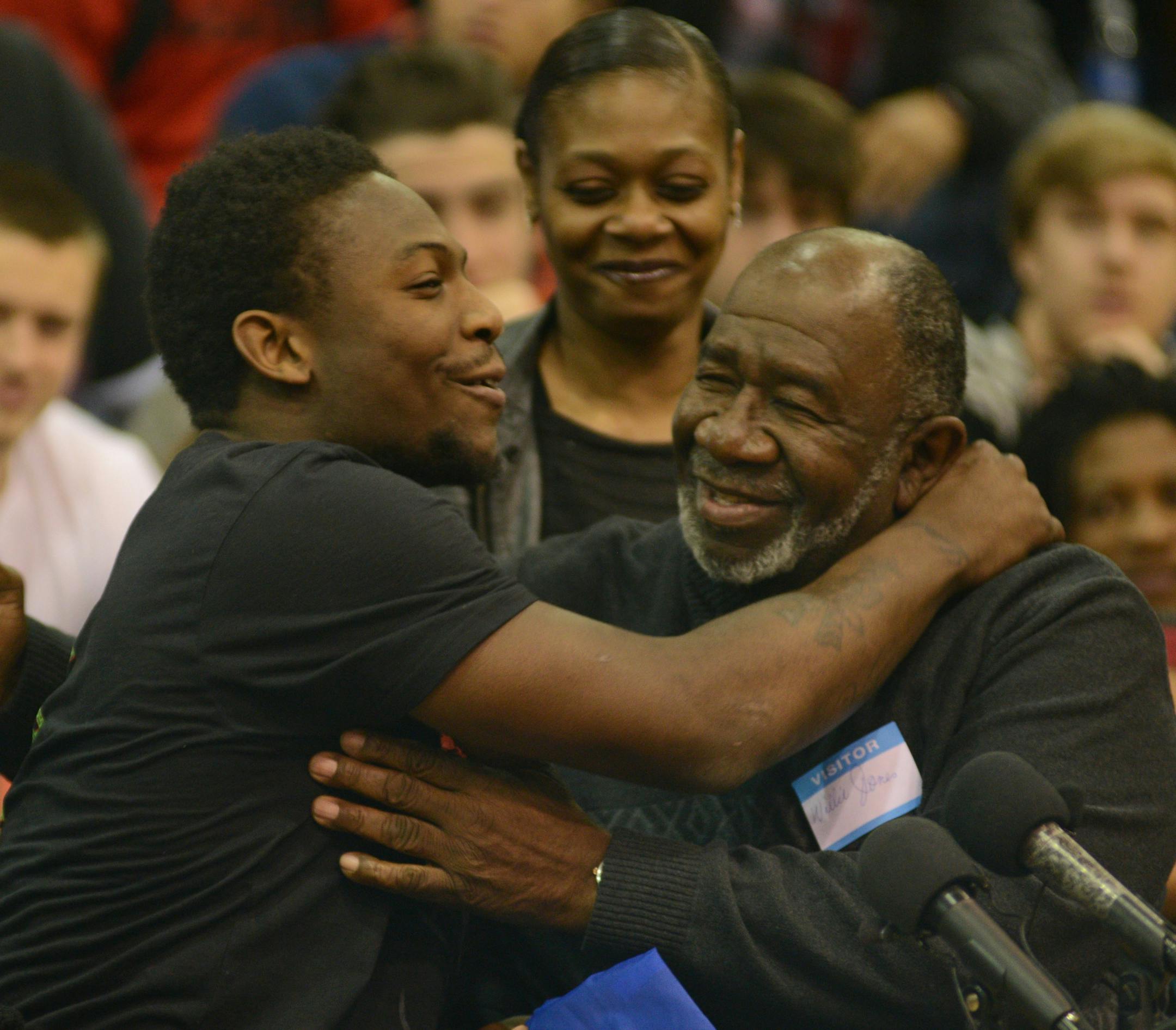 Jeff Jones, from Washburn High is one of the top running backs in the country and he selected the U of M football program . He was embraced by his grandfather Willie Jones with his mom Bernice Jones smiling in the background.] Richard.Sennott@startribune.com Richard Sennott/Star Tribune Minneapolis , Minn. Wednesday 2/5/2014) ** (cq)