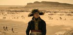 Joaquin Phoenix plays the mercurial title character in “Napoleon” with a perpetual scowl and an American accent.