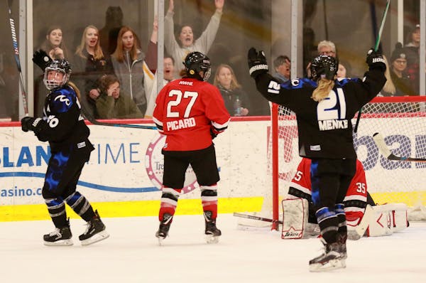 Amy Menke (21) celebrated a Minnesota Whitecaps goal by teammate Hannah Brandt in the NWHL semifinals last March.