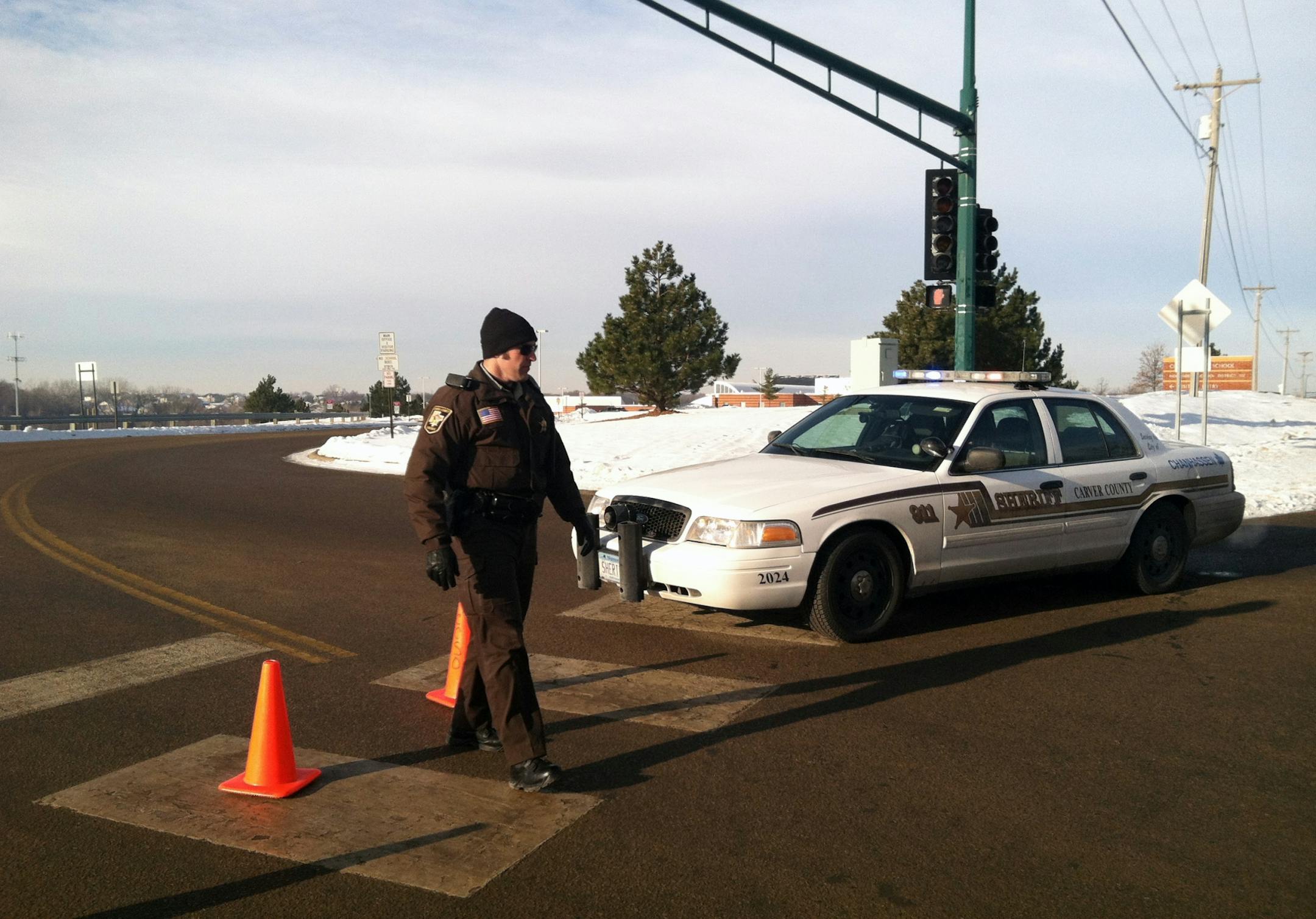Police stood guard Tuesday, Jan. 8, 2012, at the entrance to a locked-down Chaska High School.