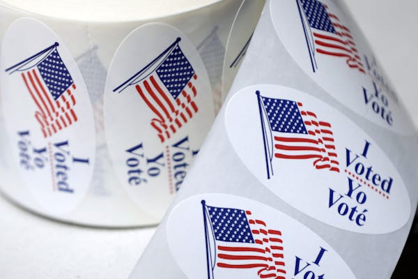 A role of "I voted" stickers in English and Spanish.