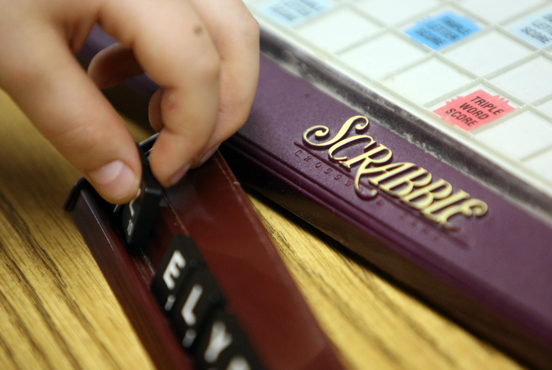 Jason Vaysberg, 14, of Plymouth arranged his letters during a game of scrabble at The Twin City Bridge Center in Minneapolis.