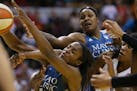 Minnesota Lynx forward Devereaux Peters (14) tried to pull down an offensive rebound with arms all around her during second quarter action.