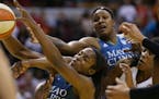 Minnesota Lynx forward Devereaux Peters (14) tried to pull down an offensive rebound with arms all around her during second quarter action.