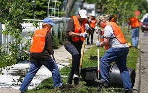 Minneapolis Park and Recreation Board Commissioners help plant a tree during the 2023 Minneapolis Arbor Day Celebration at Windom Northeast Park.