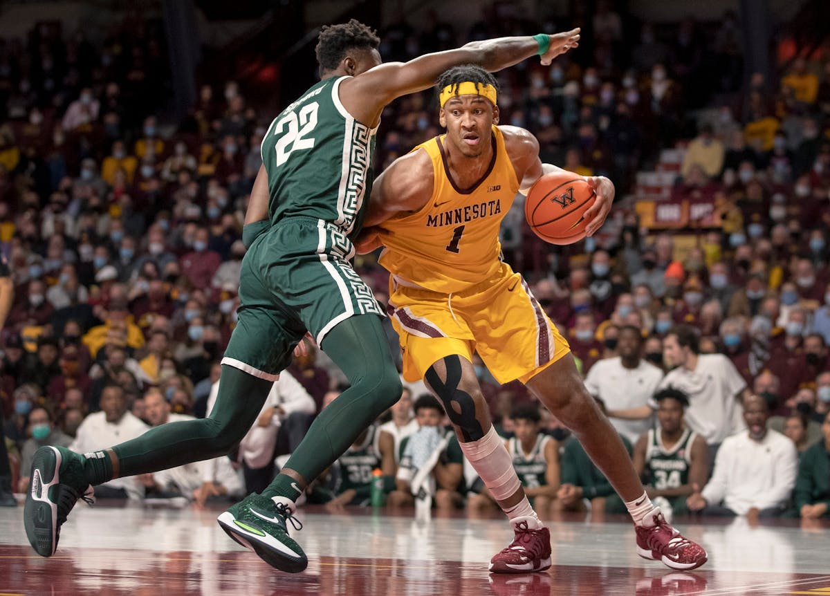 Eric Curry (1) of Minnesota is defended by Mady Sissoko (22) ) of Michigan State in the first half Wednesday, Dec. 8.
