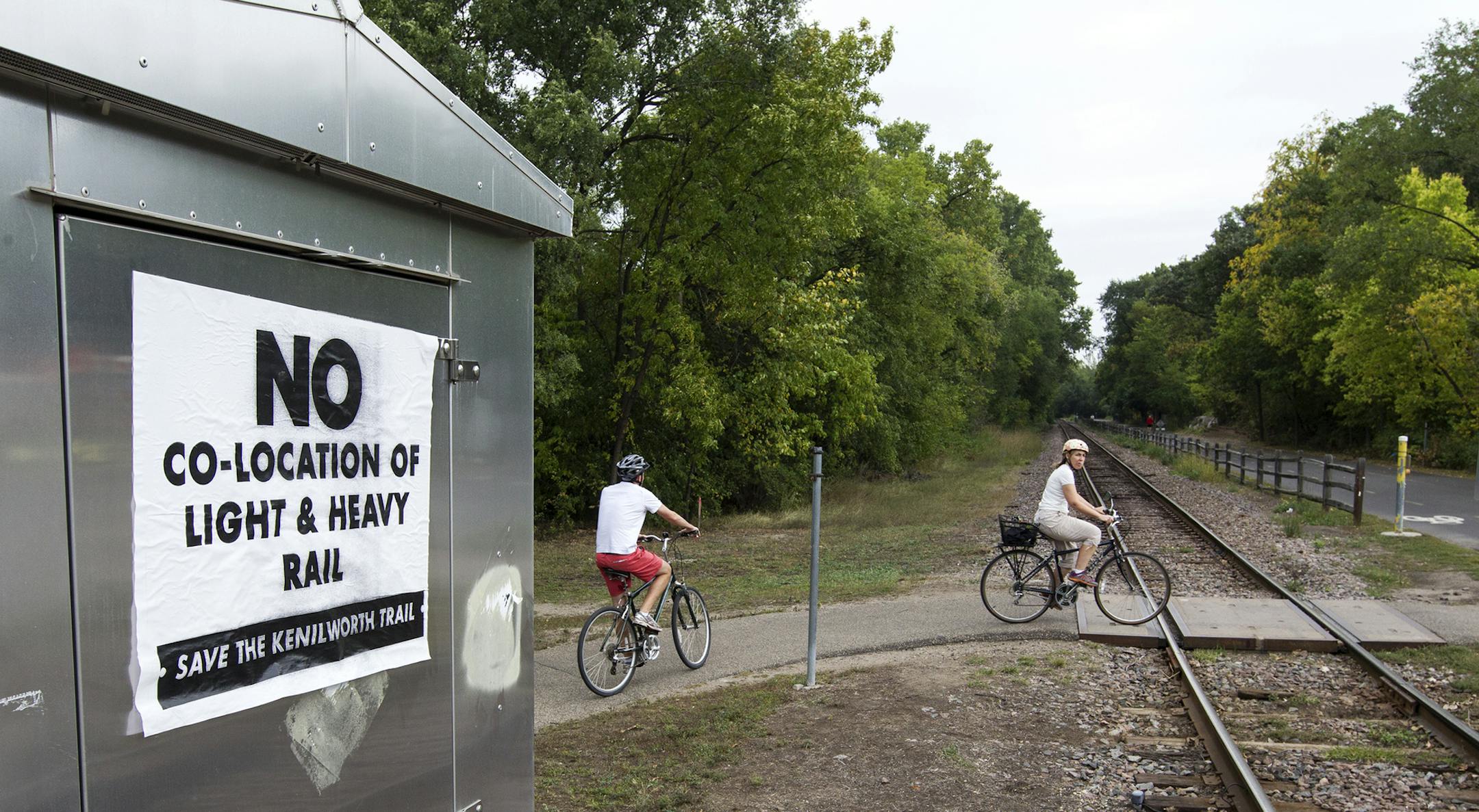 A sign on Kenilworth Trail and Cedar Lake Parkway speaks against co-location of light and heavy rail in Minneapolis, September 27, 2013.