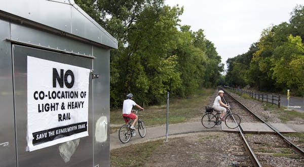 A sign on Kenilworth Trail and Cedar Lake Parkway speaks against co-location of light and heavy rail in Minneapolis, September 27, 2013.