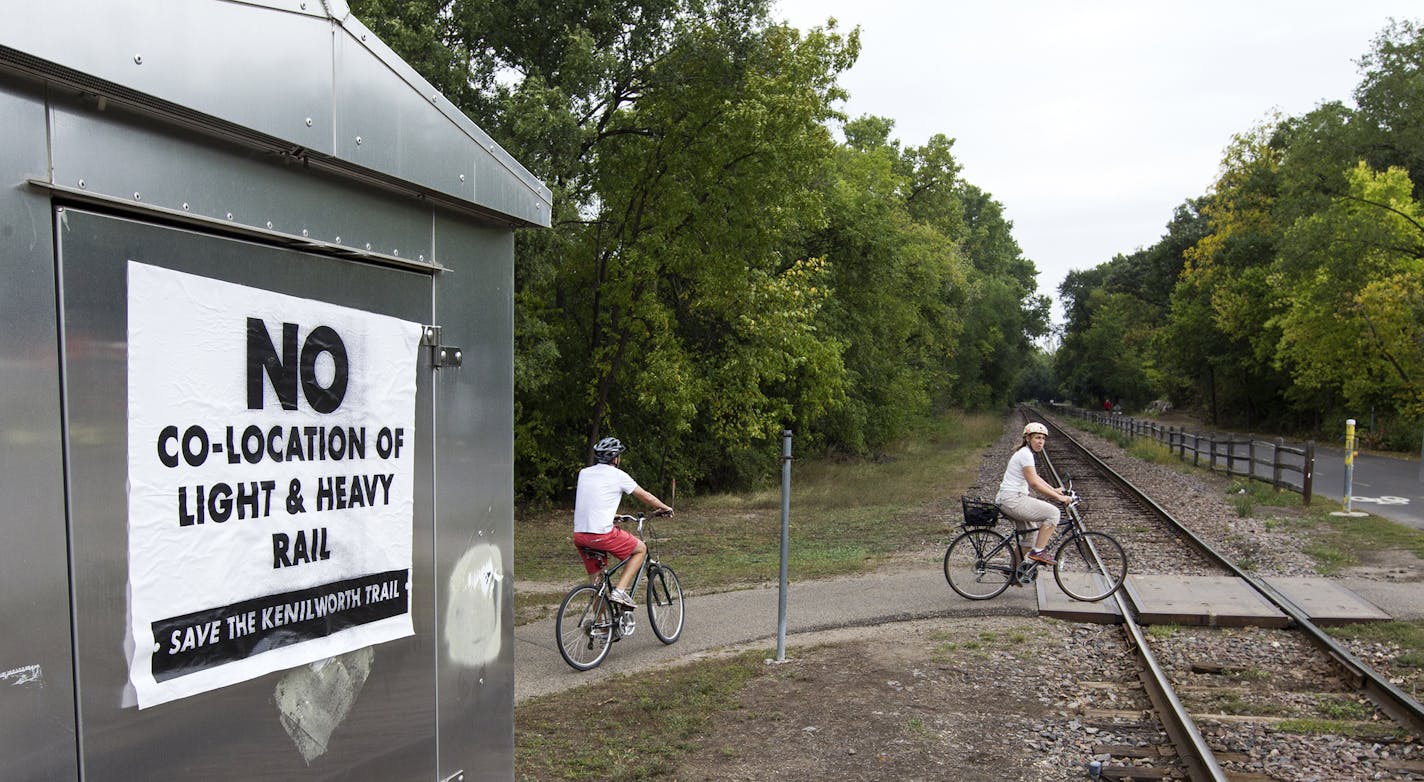 A sign on Kenilworth Trail and Cedar Lake Parkway speaks against co-location of light and heavy rail in Minneapolis, September 27, 2013.