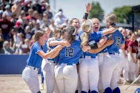 Rogers' softball players celebrate their 3-0 win over New Prague for the Class 4A title.