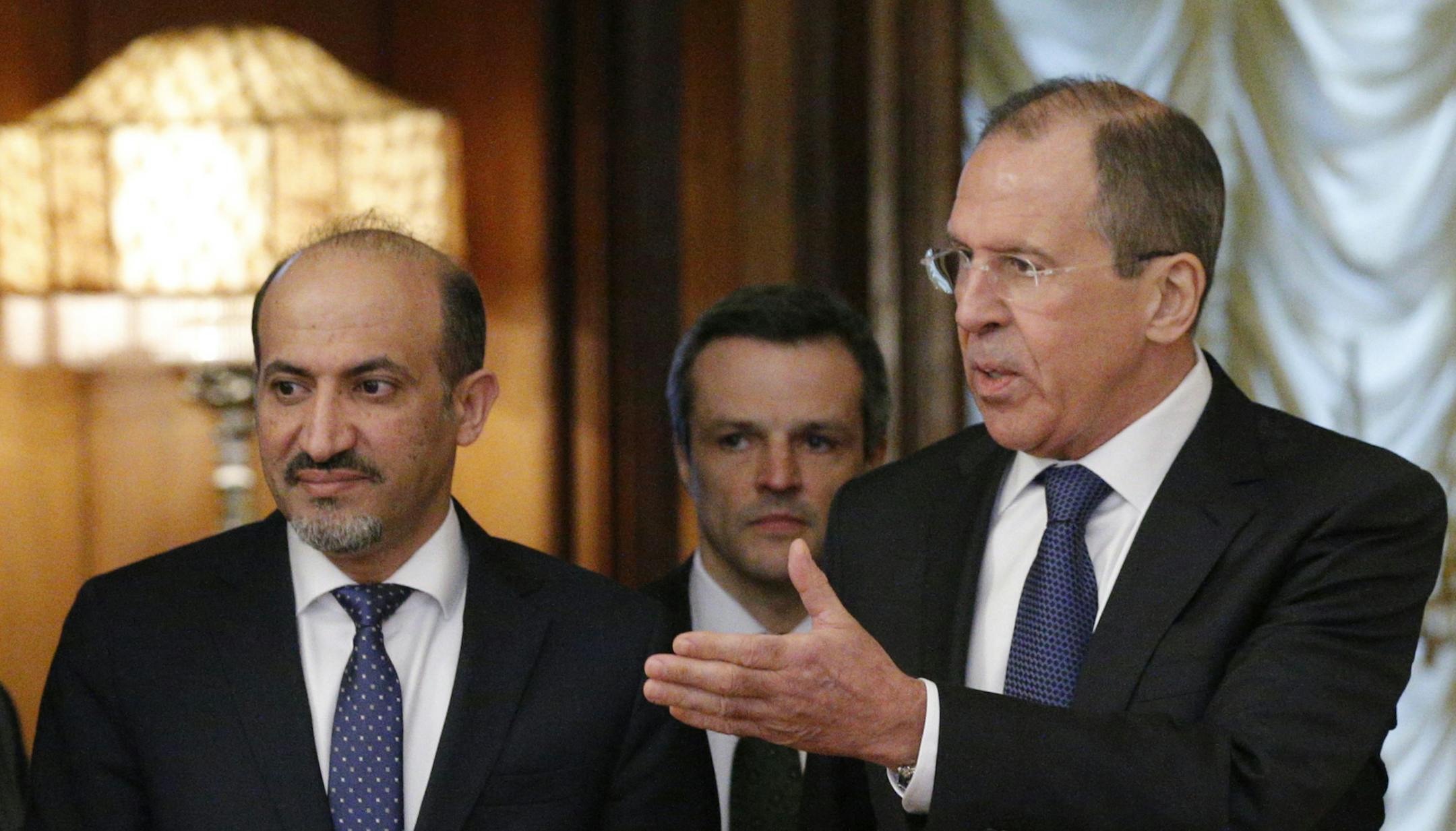 Russian foreign minister Sergey Lavrov, right, welcomes Ahmad Jarba, left, who heads a delegation of the Syrian National Coalition prior talks in Moscow Tuesday, Feb. 4, 2014. Russia welcomed the National Coalition's participation in the Montreaux conference on Syria as the confirmation of the coalition's choice in favour of a peaceful settlement of the Syrian conflict, Russian Foreign Minister Sergey Lavrov said Tuesday. (AP Photo/Alexander Zemlianichenko)