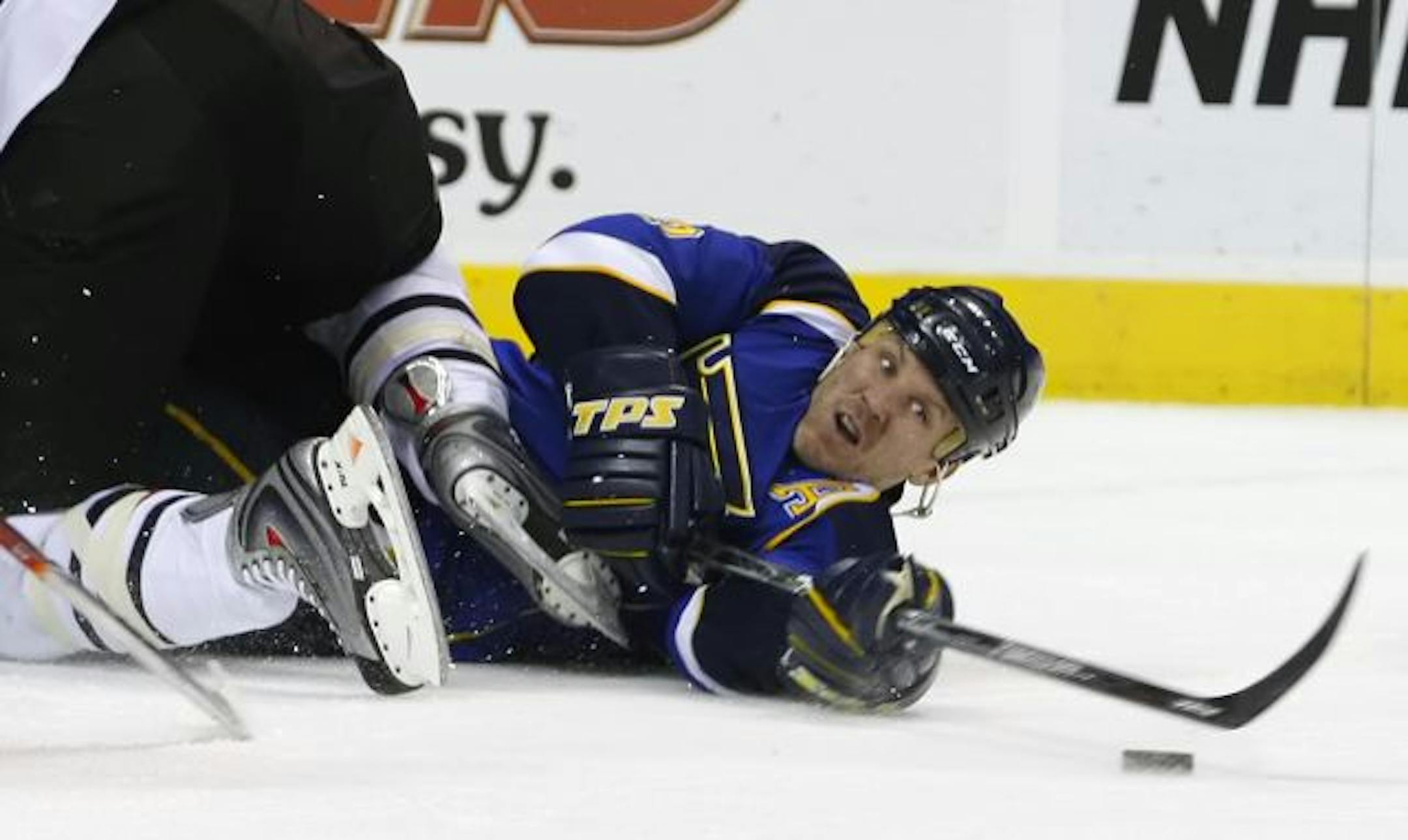 St. Louis Blues' Keith Tkachuk tries to make a play on the puck after being knocked down in the second period against the Chicago Blackhawks in an NHL hockey game, Friday, Feb. 13, 2009 in St. Louis.