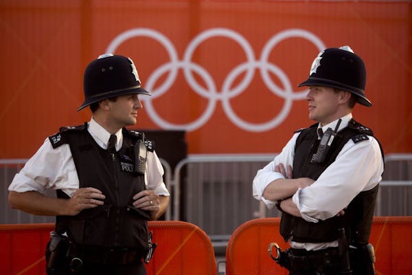 Police officers stand guard inside the Olympic Park in London.