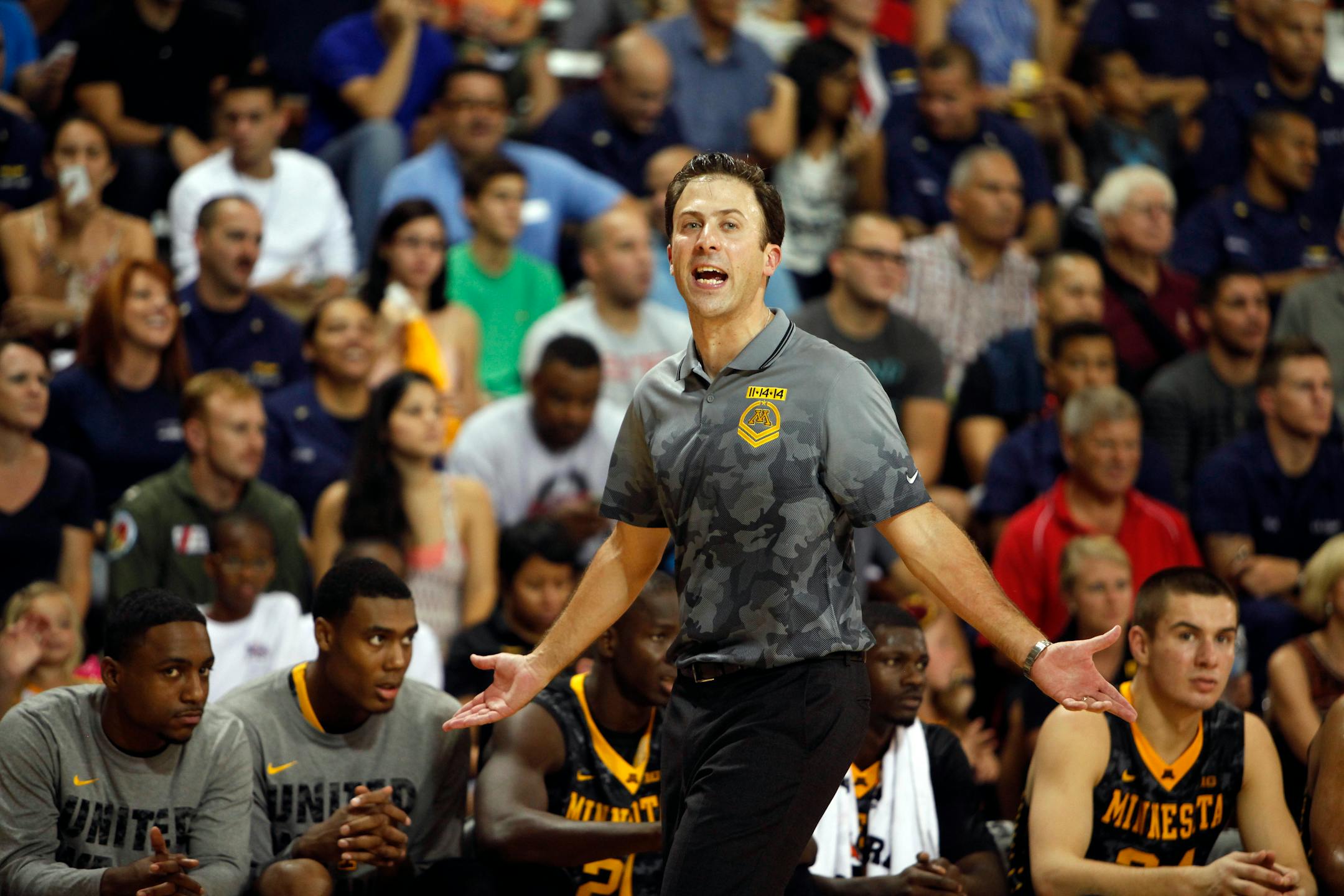 Minnesota�s head coach, Richard Pitino shouts at his team from the sidelines during an NCAA college basketball Armed Forces Classic match between Minnesota and Louisville played at a hangar at the United States Coast Guard Air Station base in Aguadilla, Puerto Rico, Friday, Nov. 14, 2014. (AP Photo/Ricardo Arduengo)