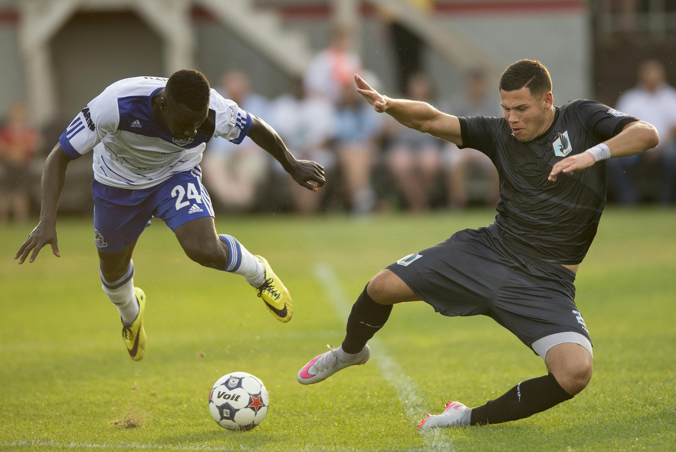 Minnesota forward Christian Ramirez (21) was tripped up by Edmonton defender Johann Smith (24) in the first half. ] Aaron Lavinsky • aaron.lavinsky@startribune.com Minnesota United FC played FC Edmonton on Saturday, August 8, 2015 at the National Sports Center in Blaine.