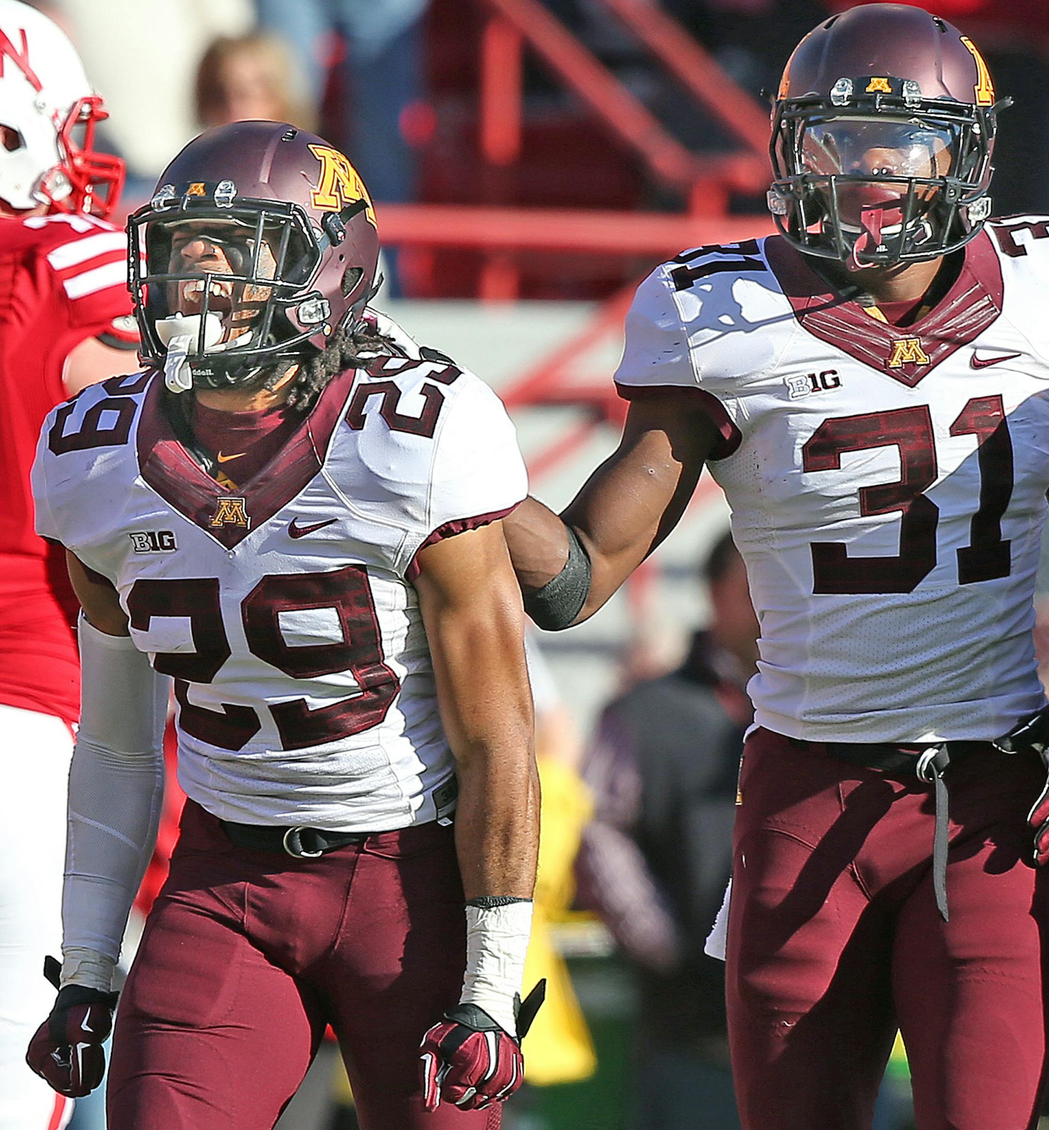 Minnesota's defensive back Briean Boddy-Calhoun (29) and defensive back Eric Murray (31) celebrated a turnover in the fourth quarter as the Minnesota Gophers took on the Nebraska Cornhuskers at Memorial Stadium, Saturday, November 22, 2014 in Lincoln, NE. ] (ELIZABETH FLORES/STAR TRIBUNE) ELIZABETH FLORES &#x2022; eflores@startribune.com