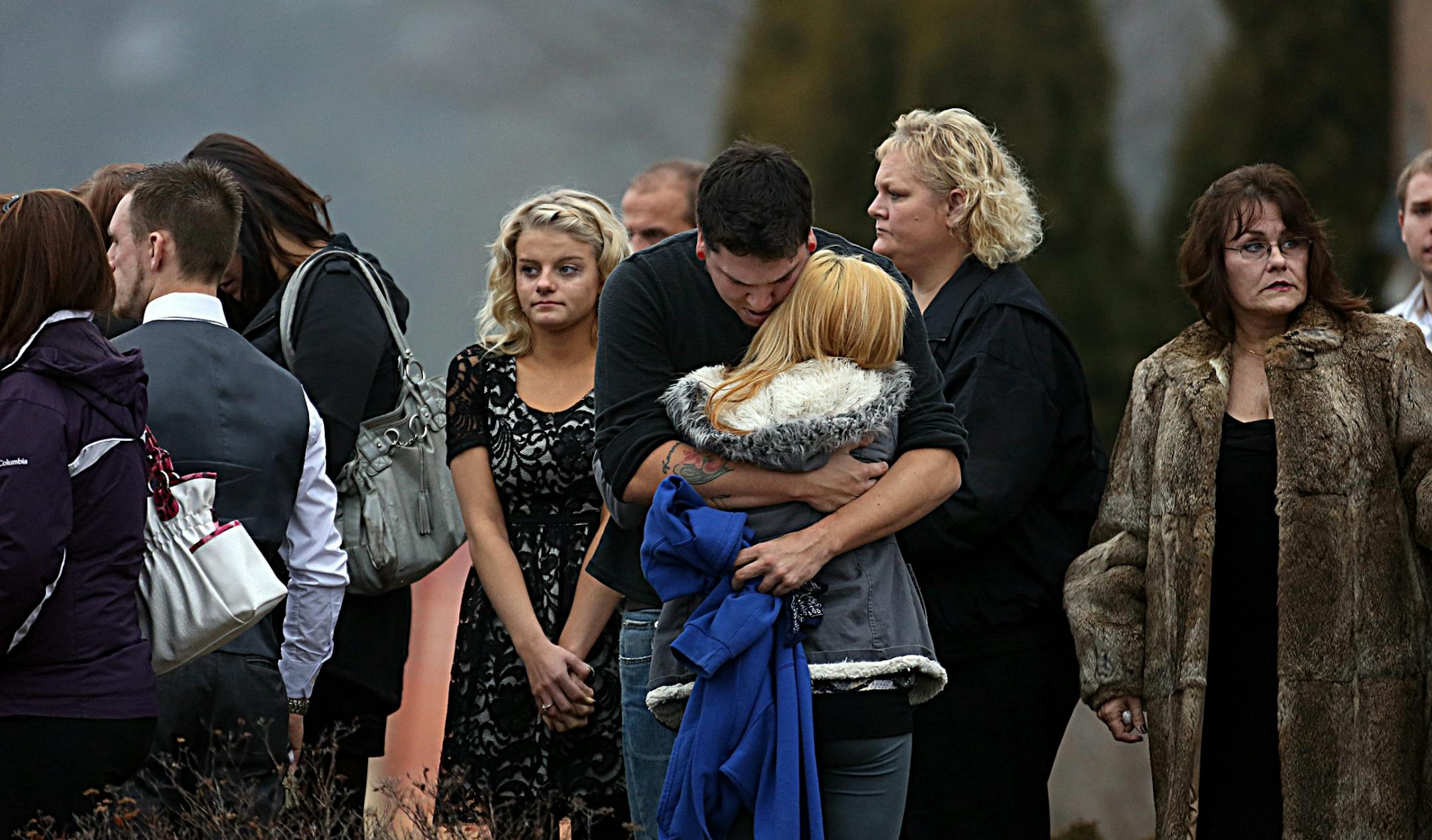 Mourners embraced following the funeral service.