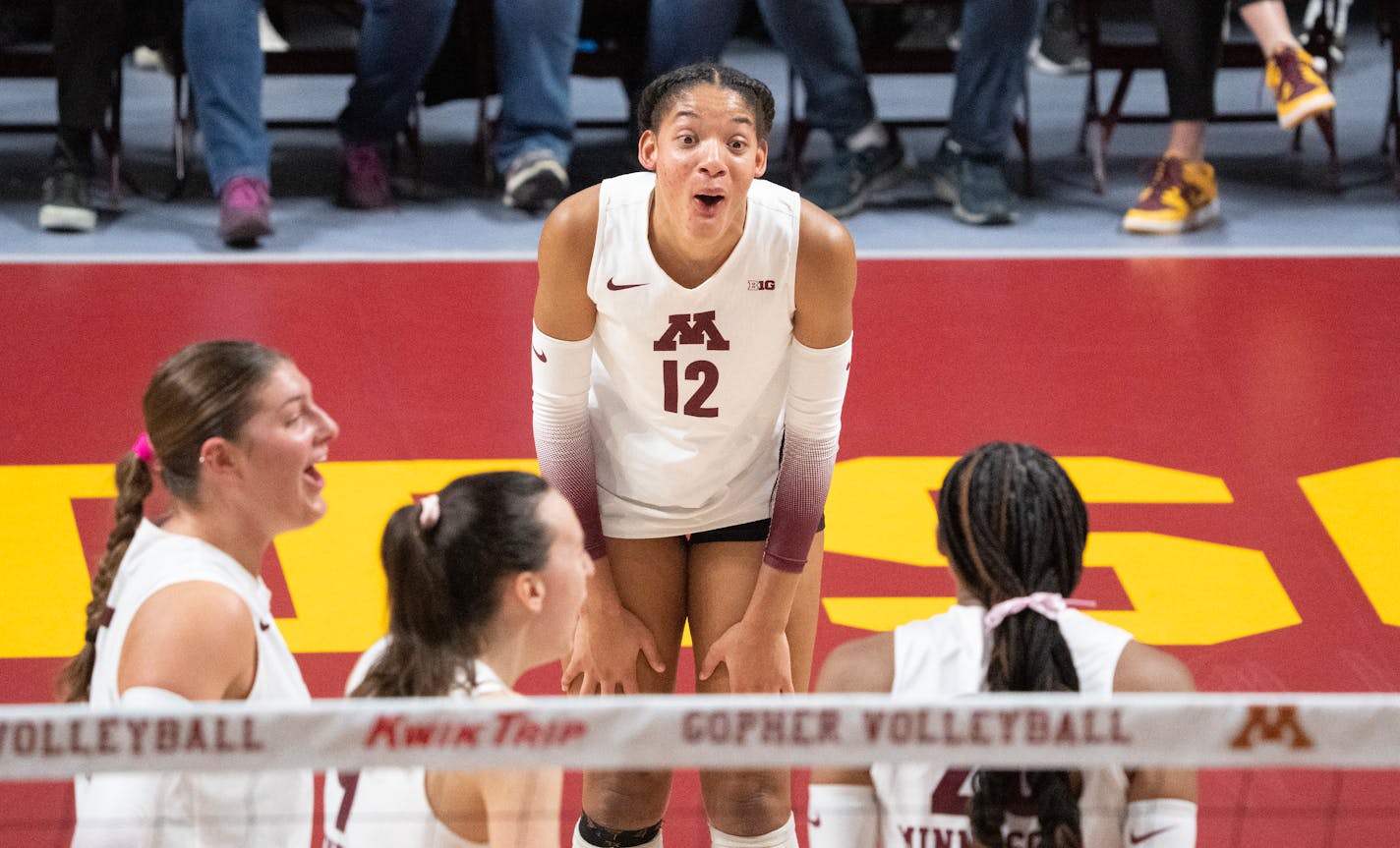 Minnesota outside Taylor Landfair (12) reacts after outside Arica Davis (20) blocked a spike for a point in the third set Friday, Nov. 10, 2023, at Maturi Pavilion at the University of Minnesota in Minneapolis, Minn. ]