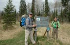 Kevin Soderholm, left, and Logan Dop at the northern terminus of the Superior Hiking Trail. ORG XMIT: z5lVtj0A4gAS79SievB0