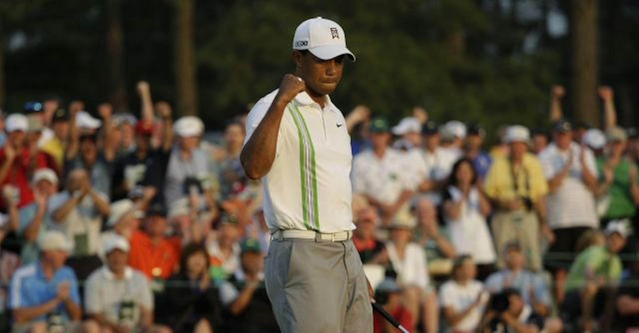 Tiger Woods pumps his fist after a birdie on the 18th hole during the second round of the Masters golf tournament Friday, April 8, 2011, in Augusta, Ga.